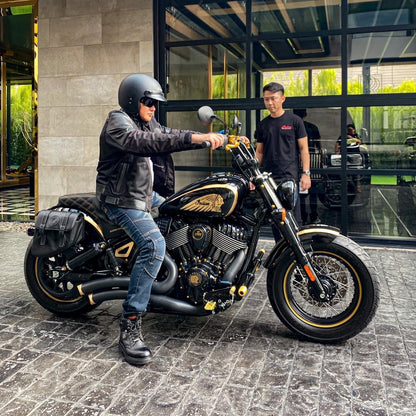 Rider on custom Indian Motorcycle with black and gold performance upgrades, Lawless Garage Quebec