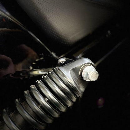 Close-up of Harley-Davidson motorcycle shock absorber, custom part, Lawless Garage Quebec Canada